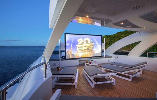Outdoor cinema with sun loungers onboard luxury yacht charter G3