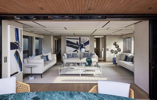Main salon onboard charter yacht LA LA LAND, spacious lounge area with plush white seating