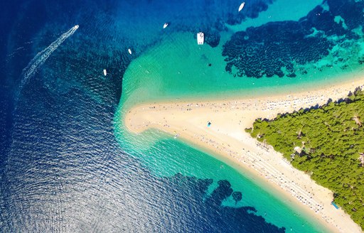 Aerial image of Croatian beach with island and white sand beach