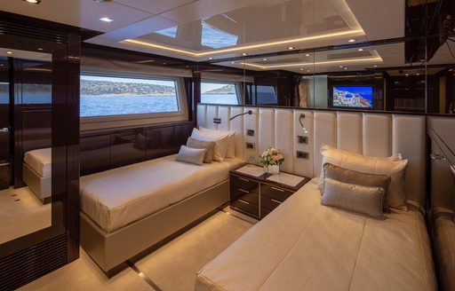 Twin guest cabin onboard charter yacht AQUA LIBRA, single berths to either side of cabin with wide window adjacent