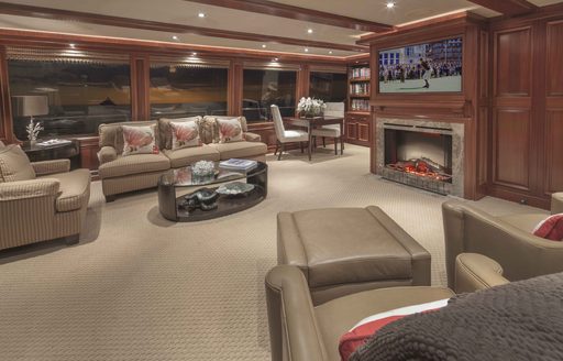 comfortable lounge with TV and fireplace on board motor yacht AMITIÉ 