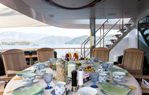 breakfast is served on upper deck alfresco dining table on luxury yacht ‘Seven Sins’ 