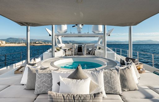 Sun deck with jacuzzi and sun pads aboard luxury yacht Her Destiny