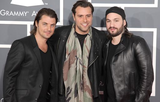 Band Swedish Mafia House posing for photo in front of grey backdrop.