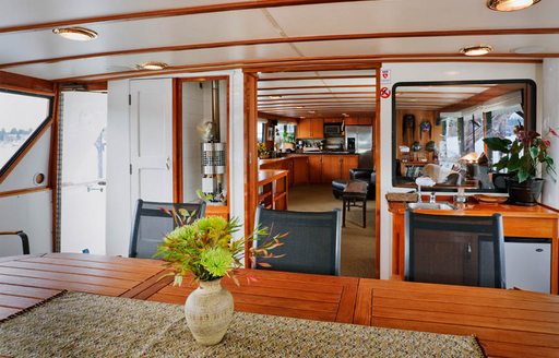 Aft deck dining area with teak wood on board luxury yacht Alaskan Sun