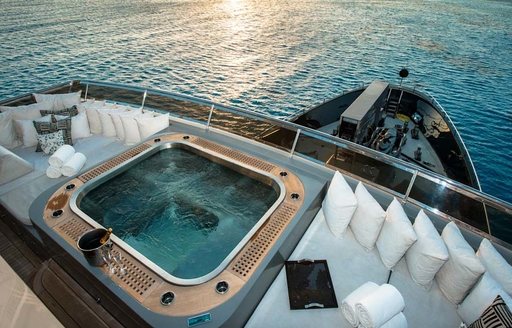 Jacuzzi surrounded by sunpads on sundeck of superyacht  ‘Plan B’ 