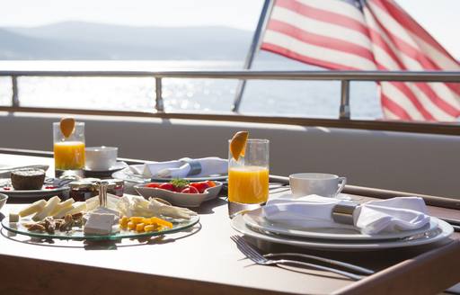 table set for an alfresco breakfast on board charter yacht NOMI