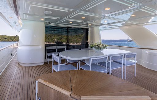 Alfresco dining area onboard charter yacht KLOBUK, large white oval table
