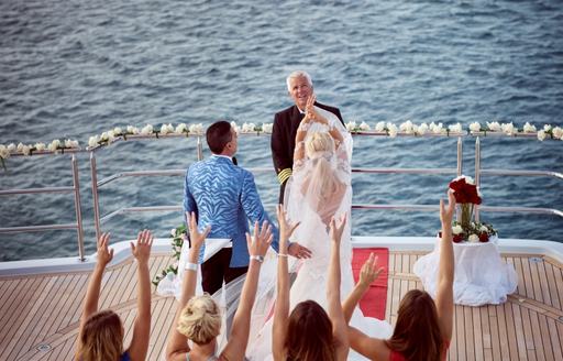 bride throws bouquet on sundeck of luxury yacht 'My Seanna' 