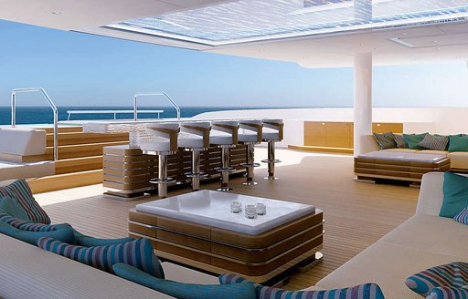 bar and sofas on the sundeck of motor yacht Illusion Plus