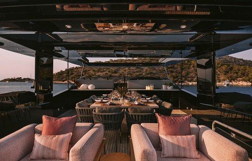 Main deck aft onboard charter yacht ISLANDER II, with alfresco lounge area and plush seating visible