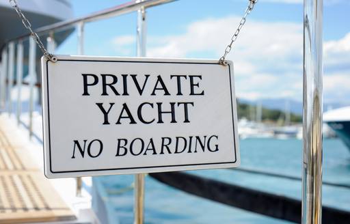 private yacht no boarding sign blocks entrance to yacht docked in Antibes