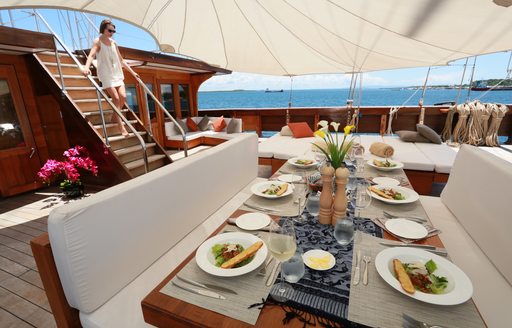 A charter guest heads onto the sundeck to enjoy some alfresco dining
