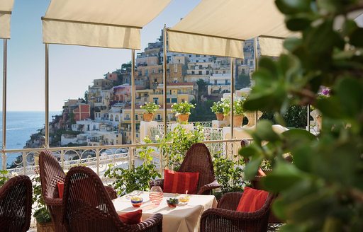 Town on the coast of Italy, with restaurant overlooking the ocean 