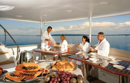 charter guests enjoy a delicious breakfast on sundeck of superyacht ‘Emerald Lady’