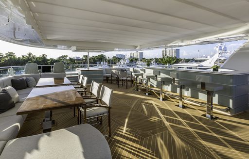 long bar and seating area opposite on sundeck of charter yacht King Baby 