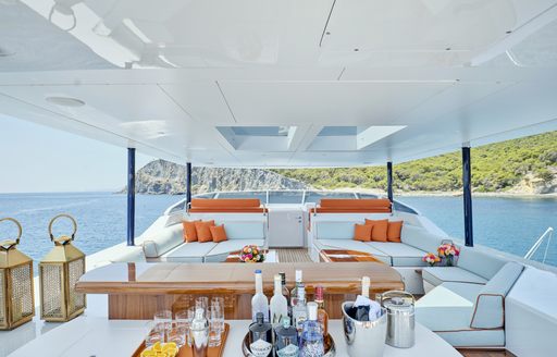 Aft main deck onboard charter yacht MIA ZOI, with alfresco lounge and dining areas
