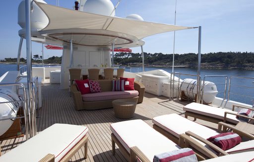 chaise loungers and alfresco lounging on sundeck of motor yacht EMOTION
