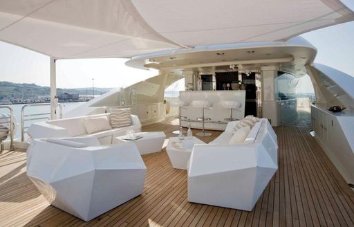 An assortment of seating on the aft deck of luxury yacht Light Holic