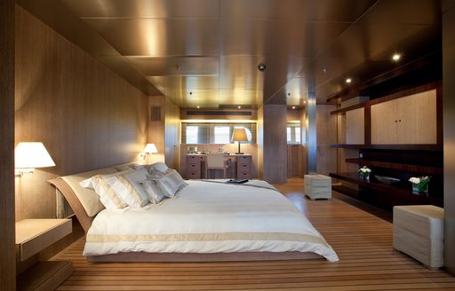 flat bed and expansive teak floors in master suite of luxury yacht MARIU 