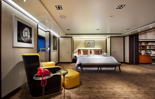 vip stateroom on motor yacht planet nine, with yellow furniture and lights below bed