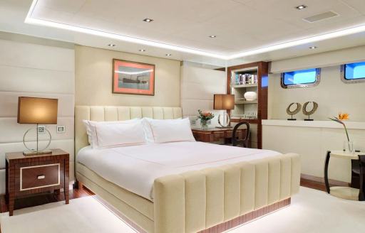 Guest cabin onboard charter yacht TIMBUKTU, central berth with two small hull windows to port side 