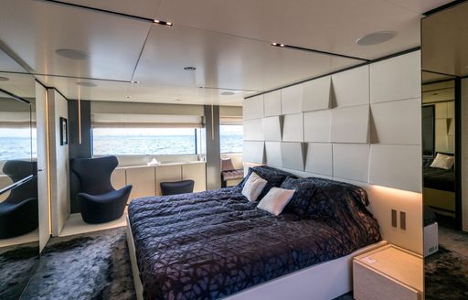 large bed in the contemporary master suite on board luxury yacht December Six 