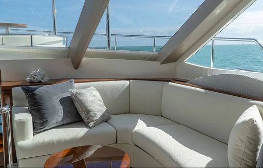 Seat with large windows adjacent to in on motor yacht ENTREPRENEUR