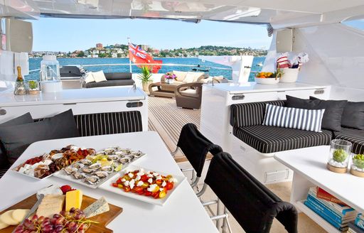 A buffet lunch is laid out on the sundeck of a charter yacht