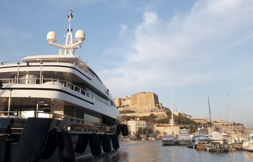 superyacht lined up in Bonifacio harbour facing citadel 