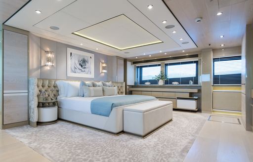 Master cabin onboard charter yacht THUMPER. Central berth facing starboard wth wide windows in background.