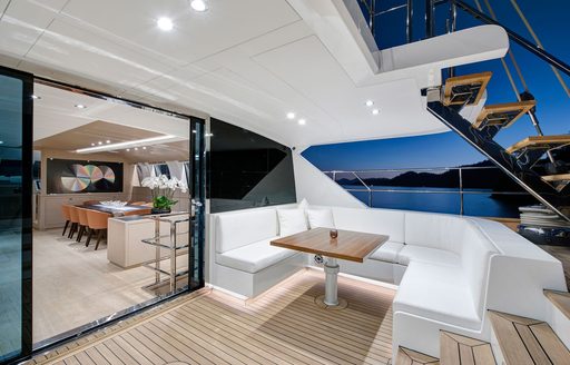 Aft deck onboard charter yacht ATLANTIKA with alfresco seating area and interiors visible through open doors