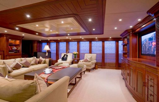 Upper salon lounge area with plush cream seating onboard charter yacht NOMAD