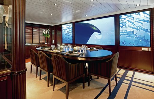 dining set-up on interior of motor yacht galileo g