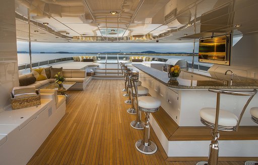 The bar and bar stools which line the upper deck of luxury yacht Silver Lining