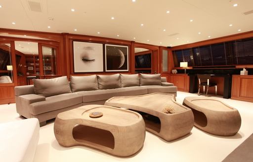 main salon of cherrywood wall panels and modern furniture on board superyacht SILENCIO