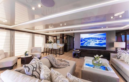 Skylounge cinema screen and comfy sofas on charter yacht Aqua Libra