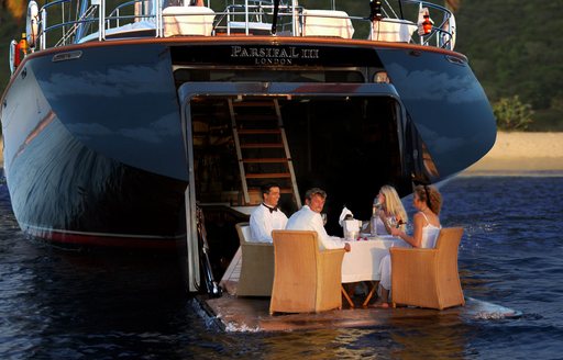 Charter guests dine on Below Deck sailing yacht, S/Y Parsifal II, on the swim platform