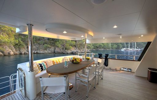 shaded al fresco dining area on the aft deck of superyacht ARCHSEA 