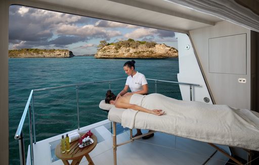 woman having a massage in Bahamas luxury yacht charter vacation