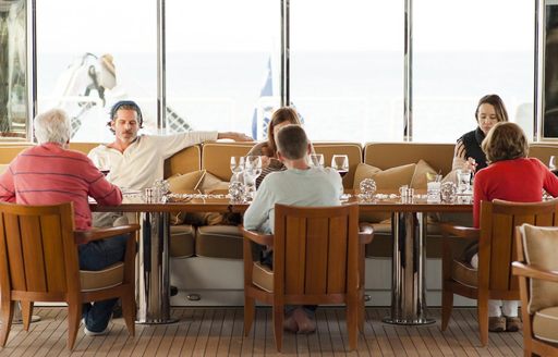 family sits down for dinner on board expedition yacht SuRi 