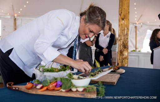 A chef at the Newport Charter Yacht Show adding finishing touches to tasters