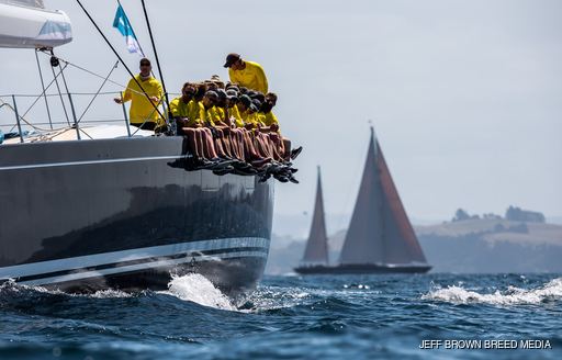 crew aboard FREYA sit on edge of yacht during the NZ Millennium Cup 2019