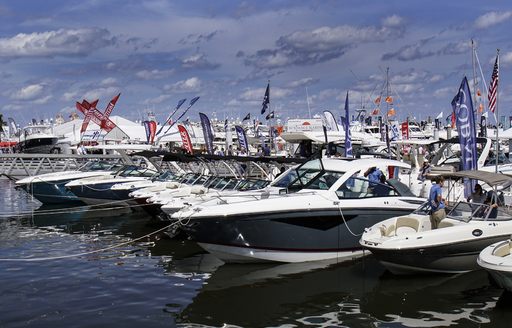 Selection of small vessels and production boats along the dock at Palm Beach Boat Show
