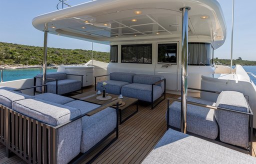 Exterior seating area shaded by a hard top onboard charter yacht KLOBUK