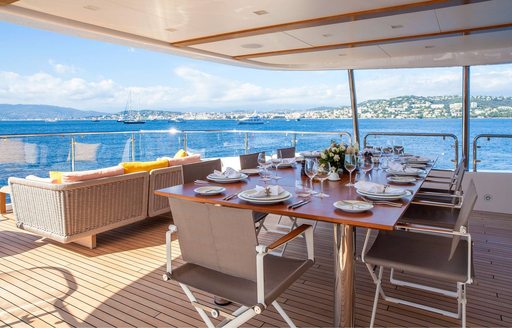 alfresco dining and seating areas on the upper deck aft of motor yacht DYNAR