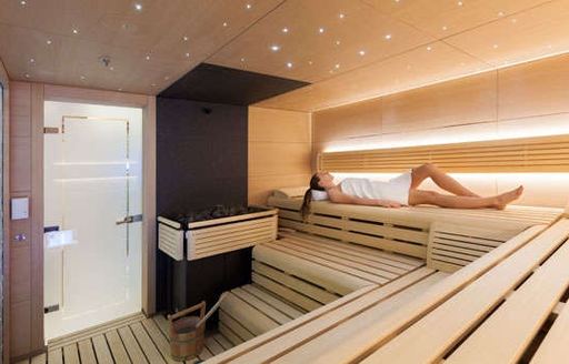 Charter guest relaxing in sauna on board motor yacht solandge