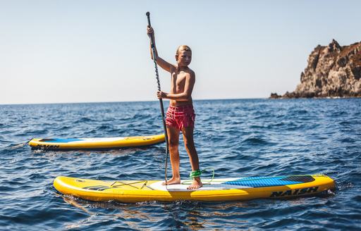 charter guest tries out the paddleboards on board superyacht Ocean View