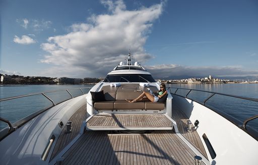female guests relaxes on sundeck of charter yacht QUANTUM