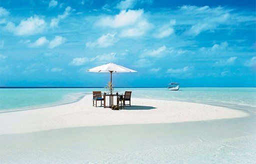 chairs on beach on maldives atoll